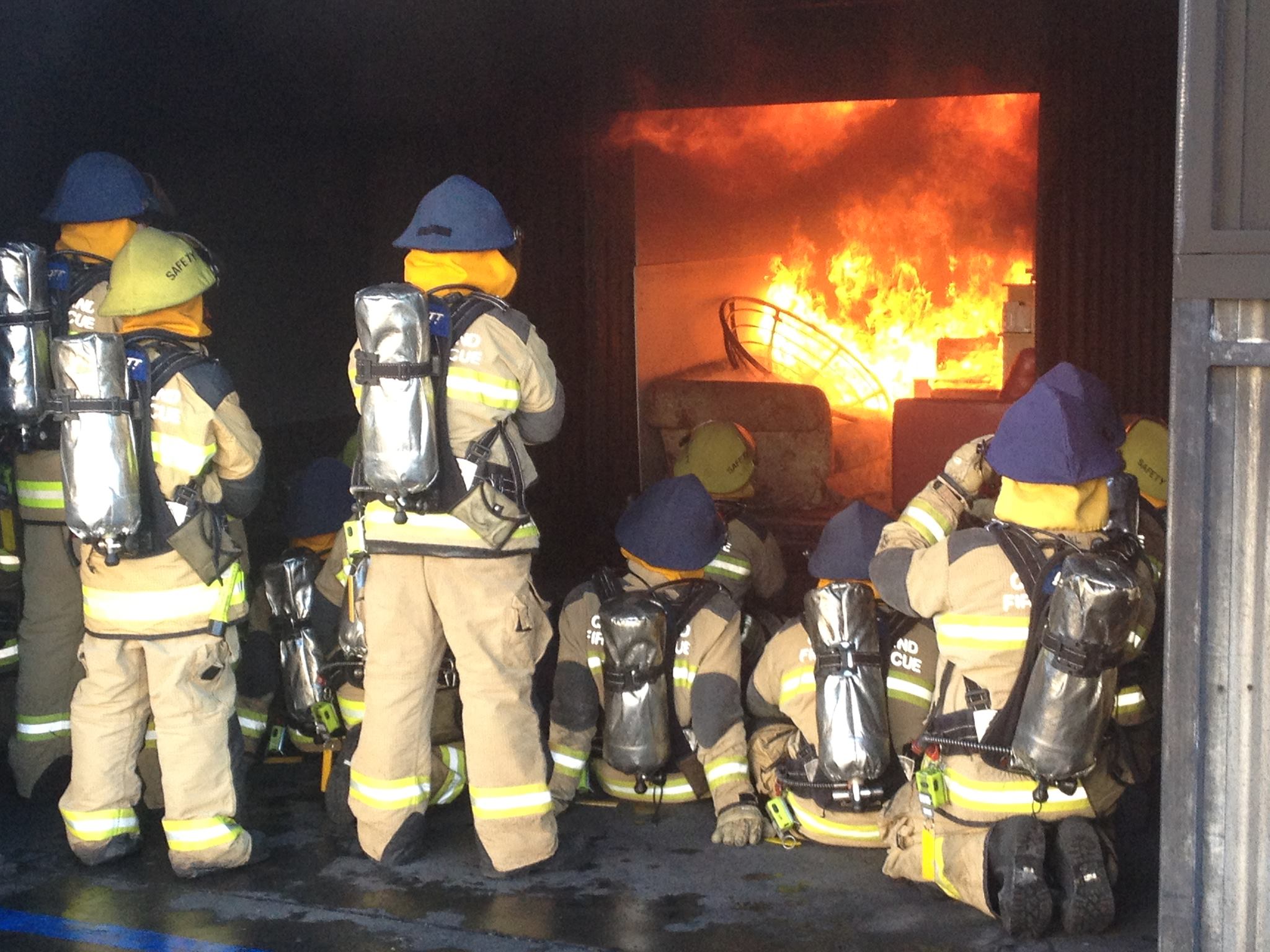 Auxiliary firefighter beside a fire appliance